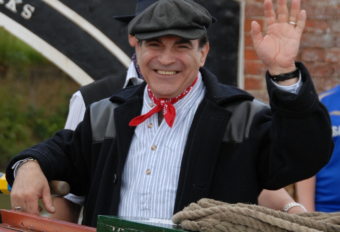 David Suchet steering narrowboat © Waterway Images