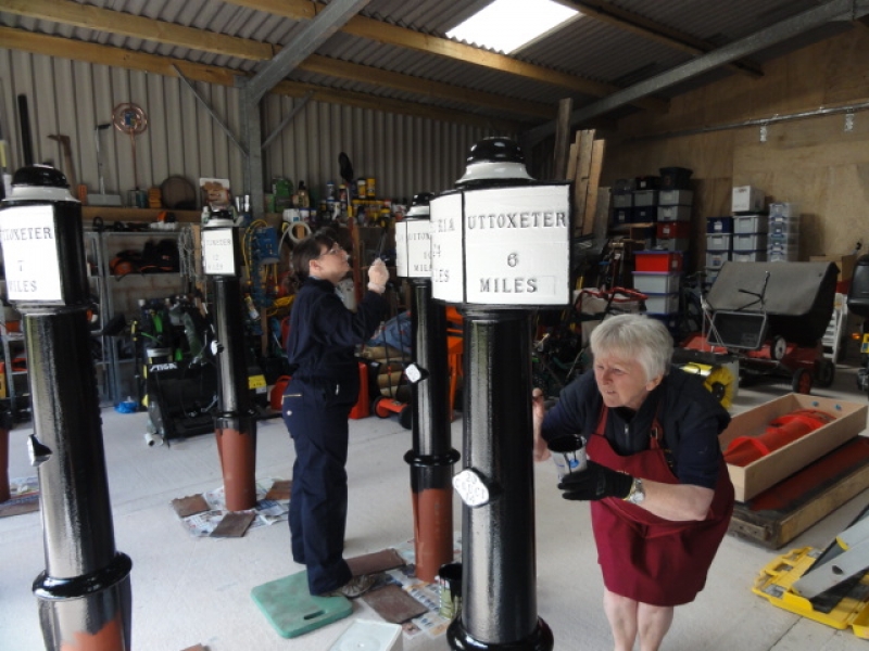 Trust volunteers Maria and Sue painting the mileposts